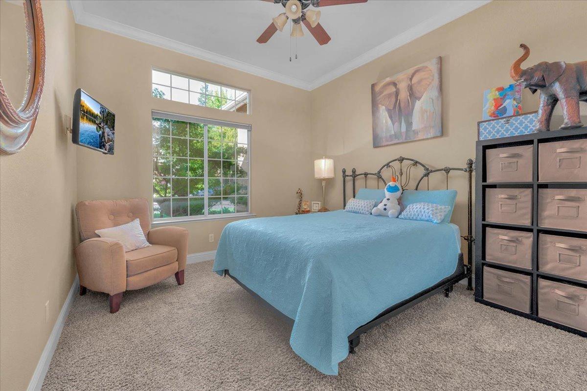 2474 Twain Avenue Clovis, CA 93611 - Photo 16 of 55 a bedroom with a bed a couch and a window