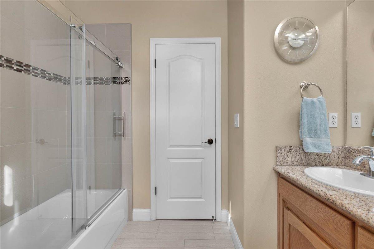 2474 Twain Avenue Clovis, CA 93611 - Photo 21 of 55 a bathroom with a granite countertop sink mirror and bathtub