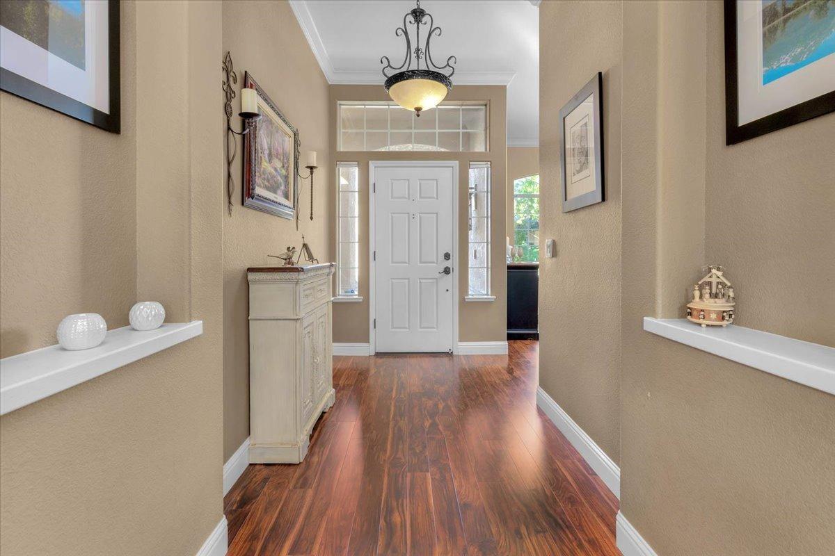 2474 Twain Avenue Clovis, CA 93611 - Photo 3 of 55 a view of a hallway with wooden floor and staircase