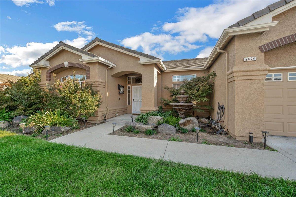 2474 Twain Avenue Clovis, CA 93611 - Photo 53 of 55 a front view of a house with a garden