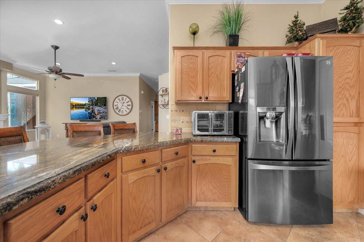 2474 Twain Avenue Clovis, CA 93611 - Photo 6 of 55 a kitchen with stainless steel appliances granite countertop a refrigerator a sink and white cabinets