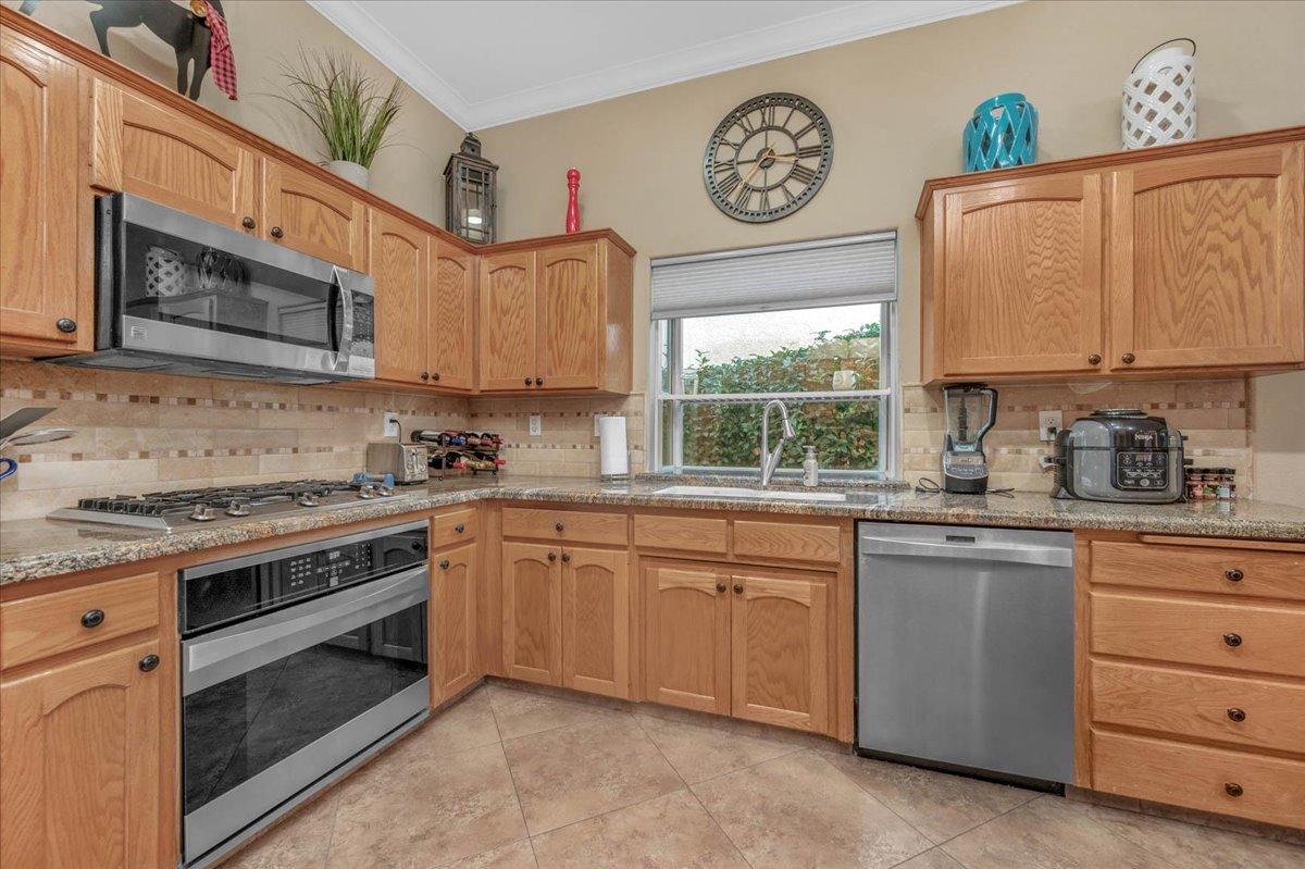 2474 Twain Avenue Clovis, CA 93611 - Photo 7 of 55 a kitchen with cabinets appliances and a window