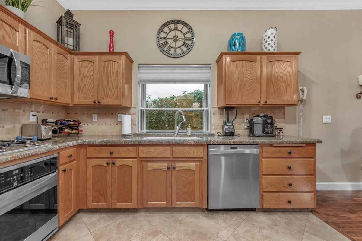 2474 Twain Avenue Clovis, CA 93611 - Photo 8 of 55 a kitchen with a stove a sink and a microwave