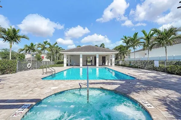 a view of house with swimming pool outdoor seating