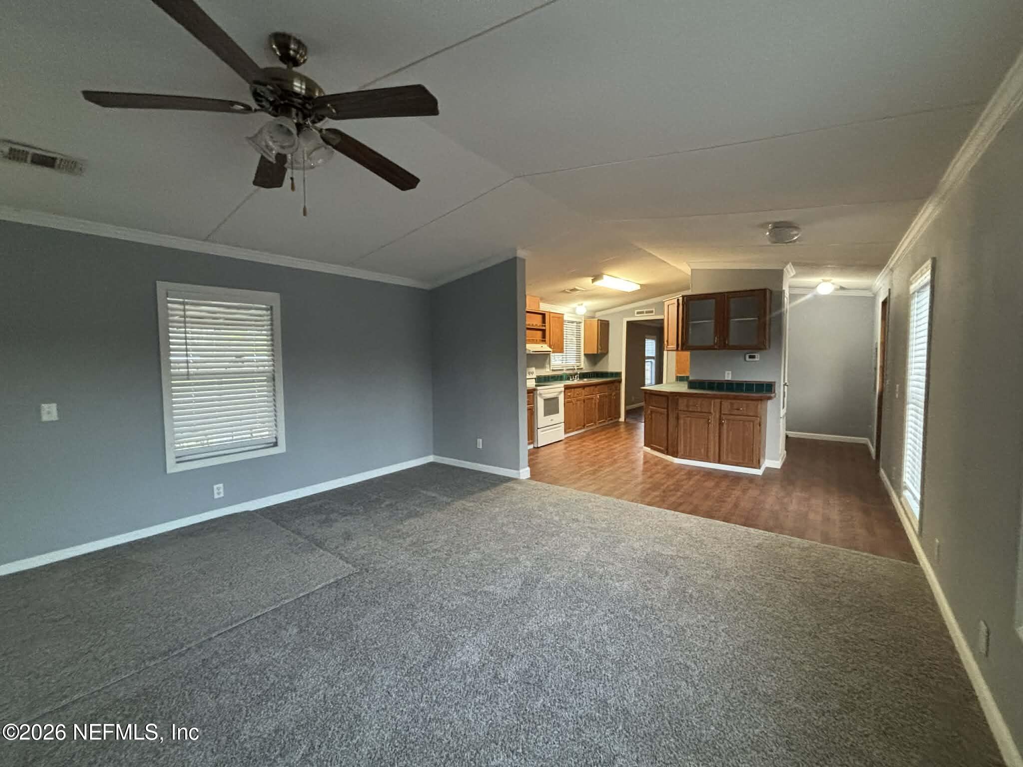 7624 Southwest County Road 225 Starke, FL 32091 - Photo 12 of 56 a view of empty room with wooden floor and windows