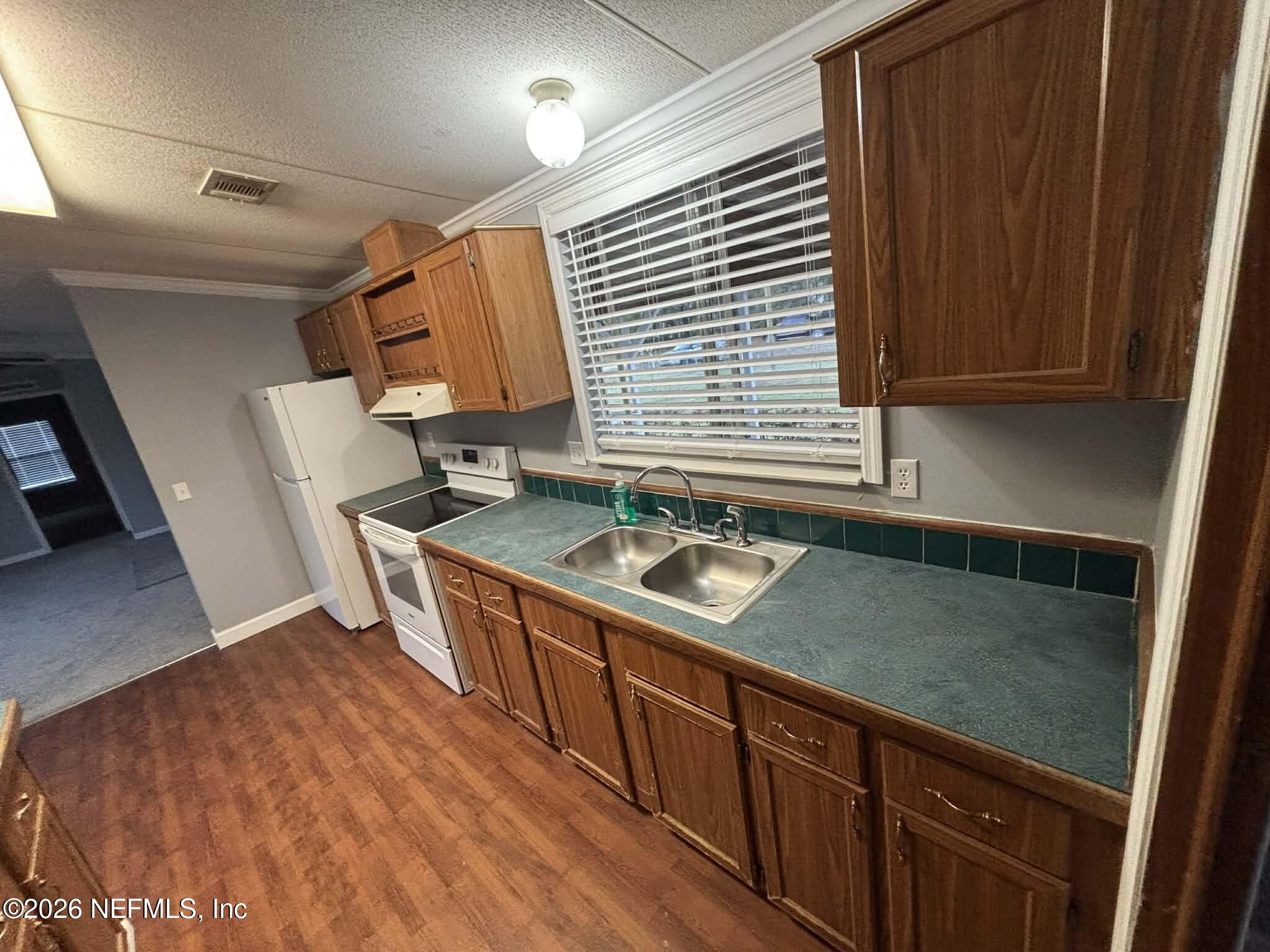 7624 Southwest County Road 225 Starke, FL 32091 - Photo 16 of 56 a kitchen with stainless steel appliances granite countertop a sink stove and cabinets