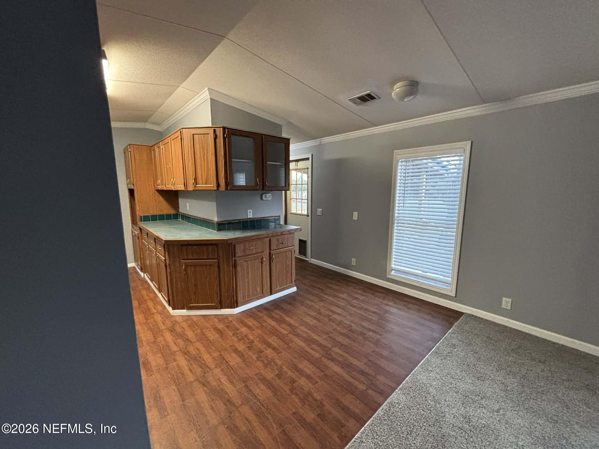 7624 Southwest County Road 225 Starke, FL 32091 - Photo 19 of 56 a kitchen with stainless steel appliances granite countertop a sink and a stove