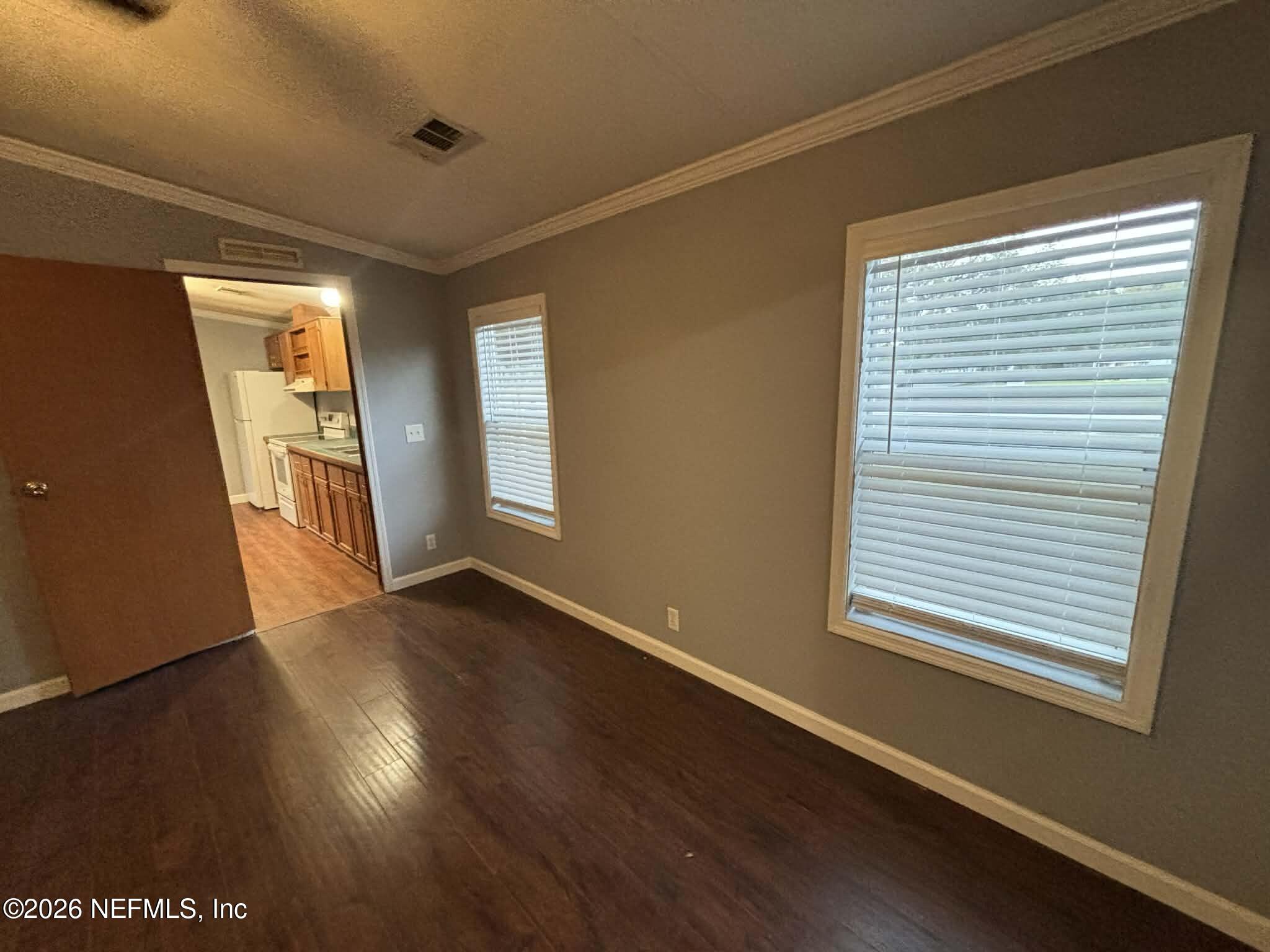 7624 Southwest County Road 225 Starke, FL 32091 - Photo 23 of 56 a view of an empty room with wooden floor and a window