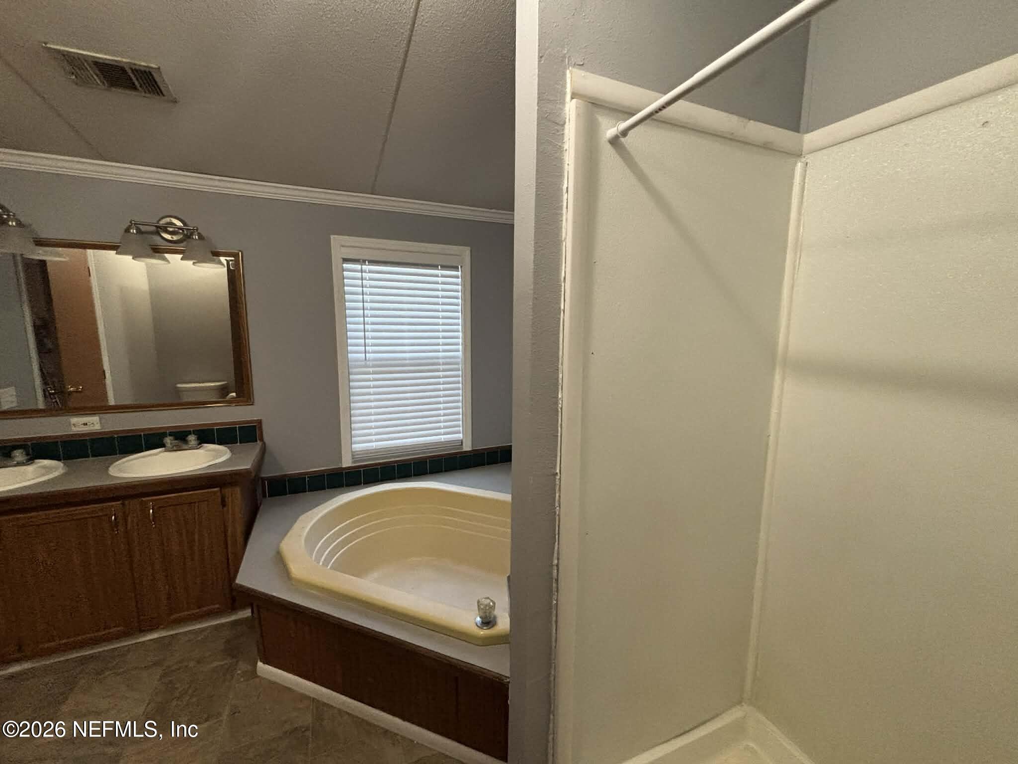 7624 Southwest County Road 225 Starke, FL 32091 - Photo 27 of 56 a bathroom with a tub sink and mirror