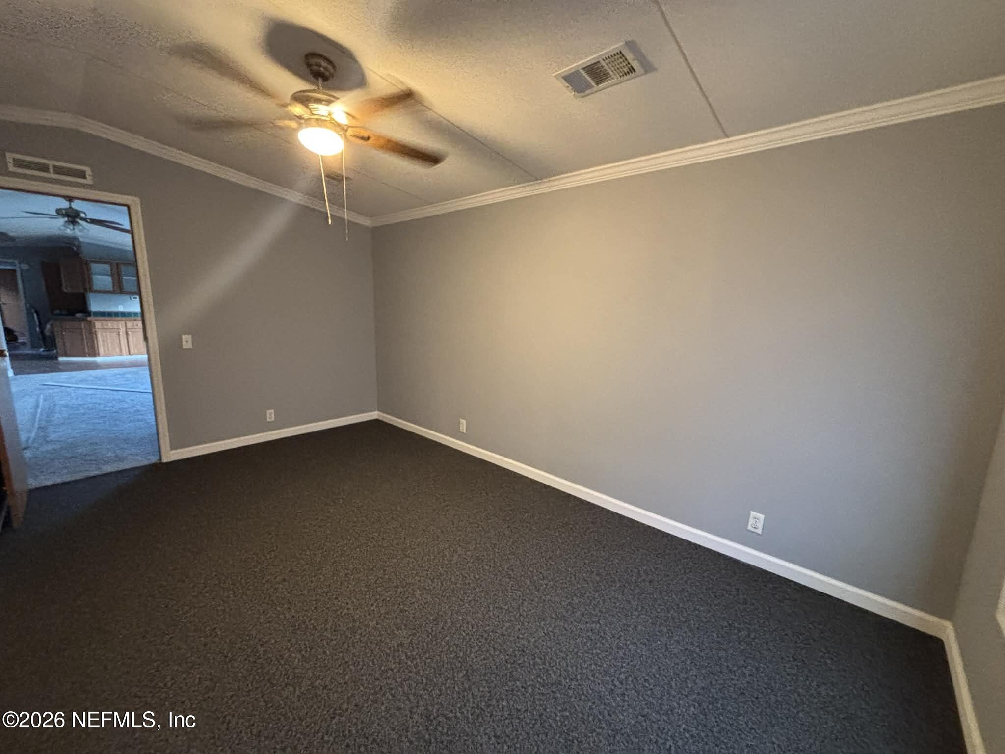 7624 Southwest County Road 225 Starke, FL 32091 - Photo 32 of 56 an empty room with a ceiling fan and a window