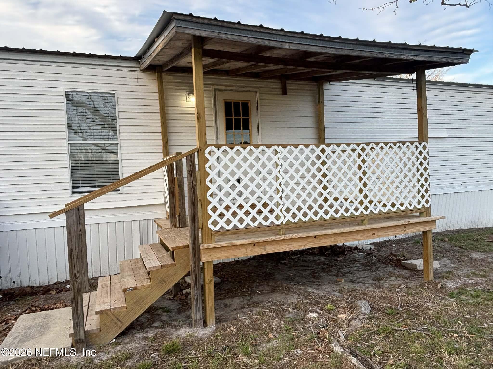 7624 Southwest County Road 225 Starke, FL 32091 - Photo 36 of 56 a backyard of a house with a bench