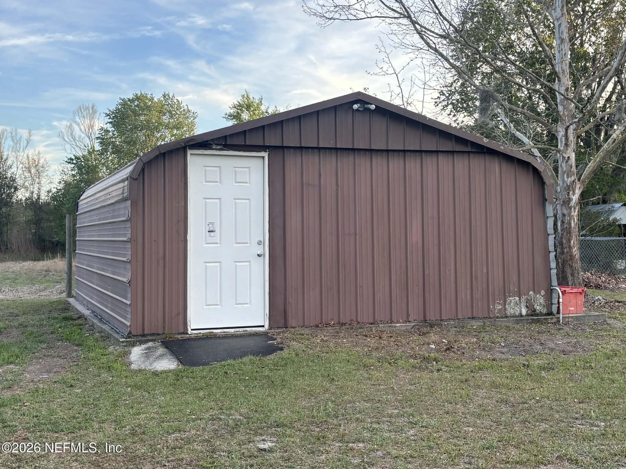7624 Southwest County Road 225 Starke, FL 32091 - Photo 42 of 56 a wooden house with a wooden fence and a small yard