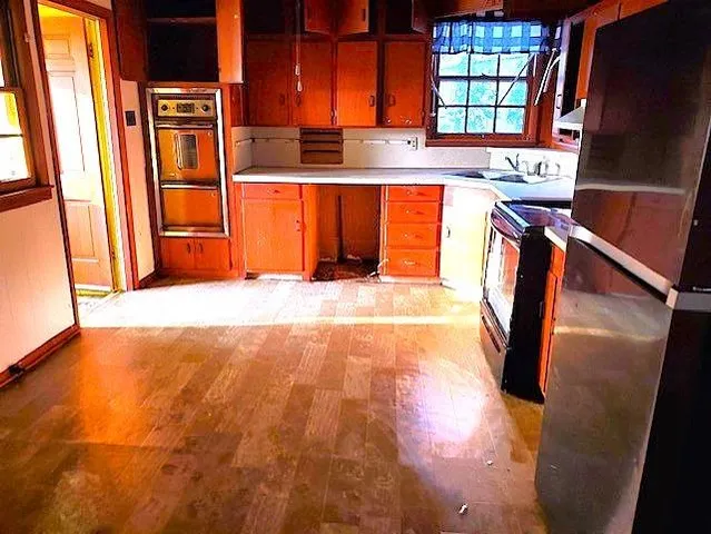 wooden floor in an empty room with a window