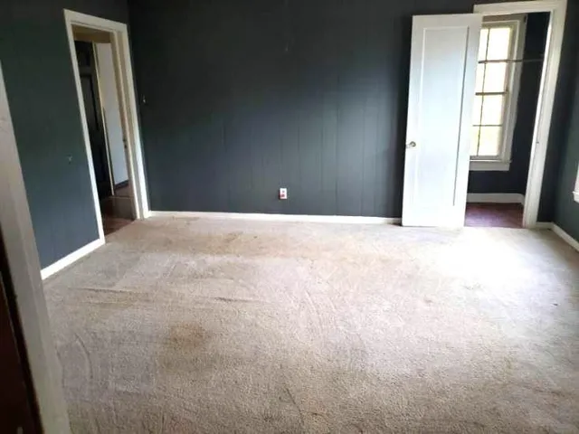 a view of an empty room and a window