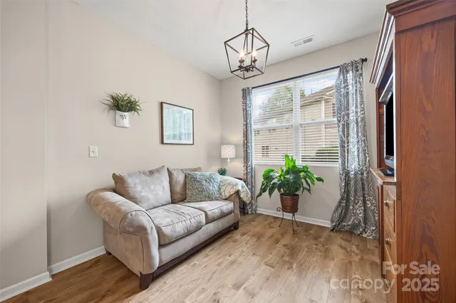 a living room with furniture and a chandelier