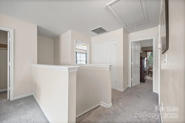 a view of hallway with wooden floor