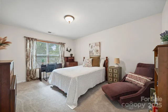 a spacious bedroom with two beds and large window