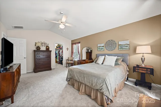 a bedroom with a bed and a television