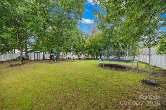 a view of a swimming pool with an outdoor seating and a yard