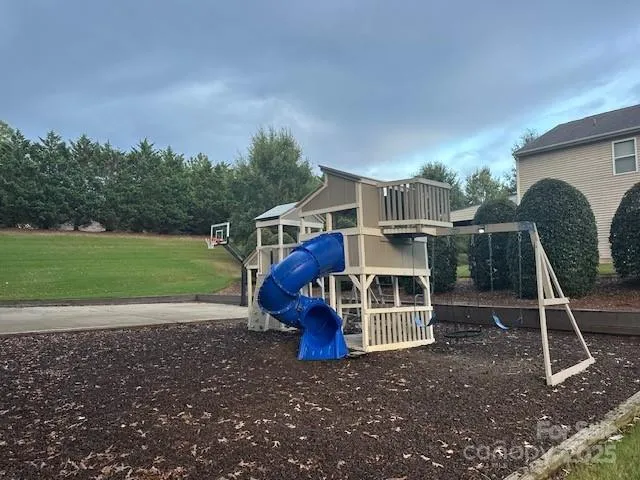 a view of a house with a yard and sitting area