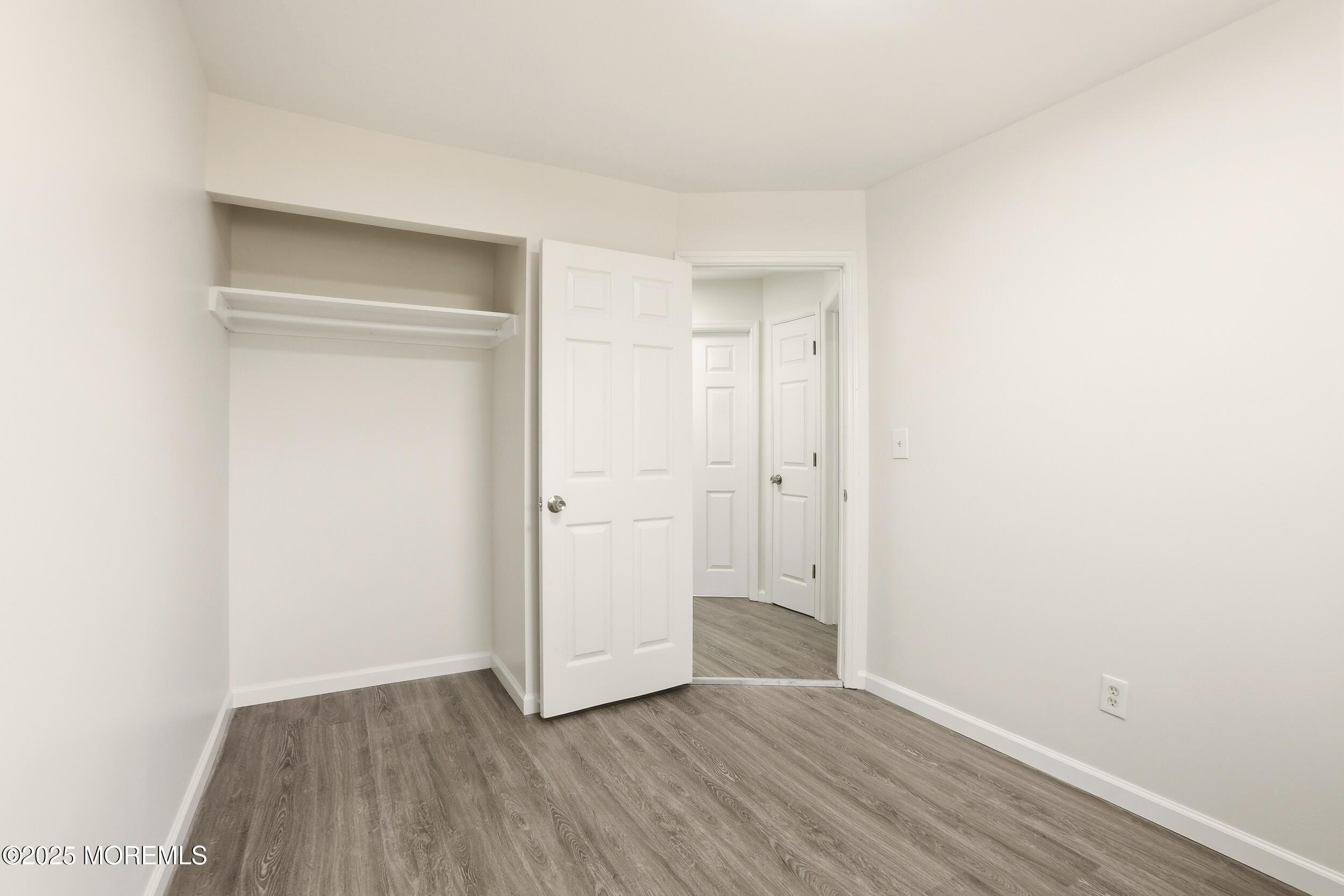28 Brandies Road Toms River, NJ 08757 - Photo 20 of 30 a view of an empty room with wooden floor and closet