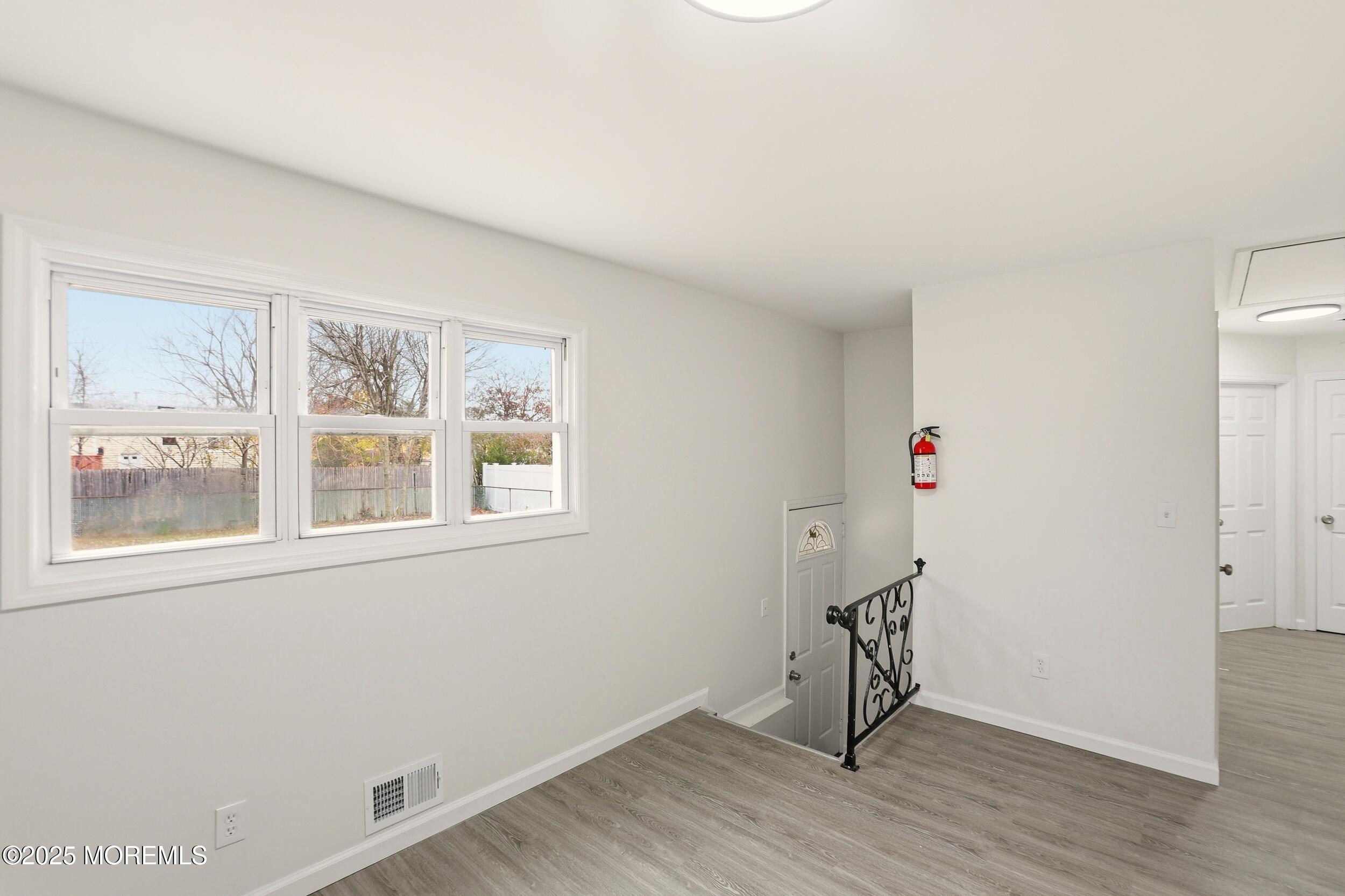 28 Brandies Road Toms River, NJ 08757 - Photo 21 of 30 a view of an empty room with wooden floor and a window