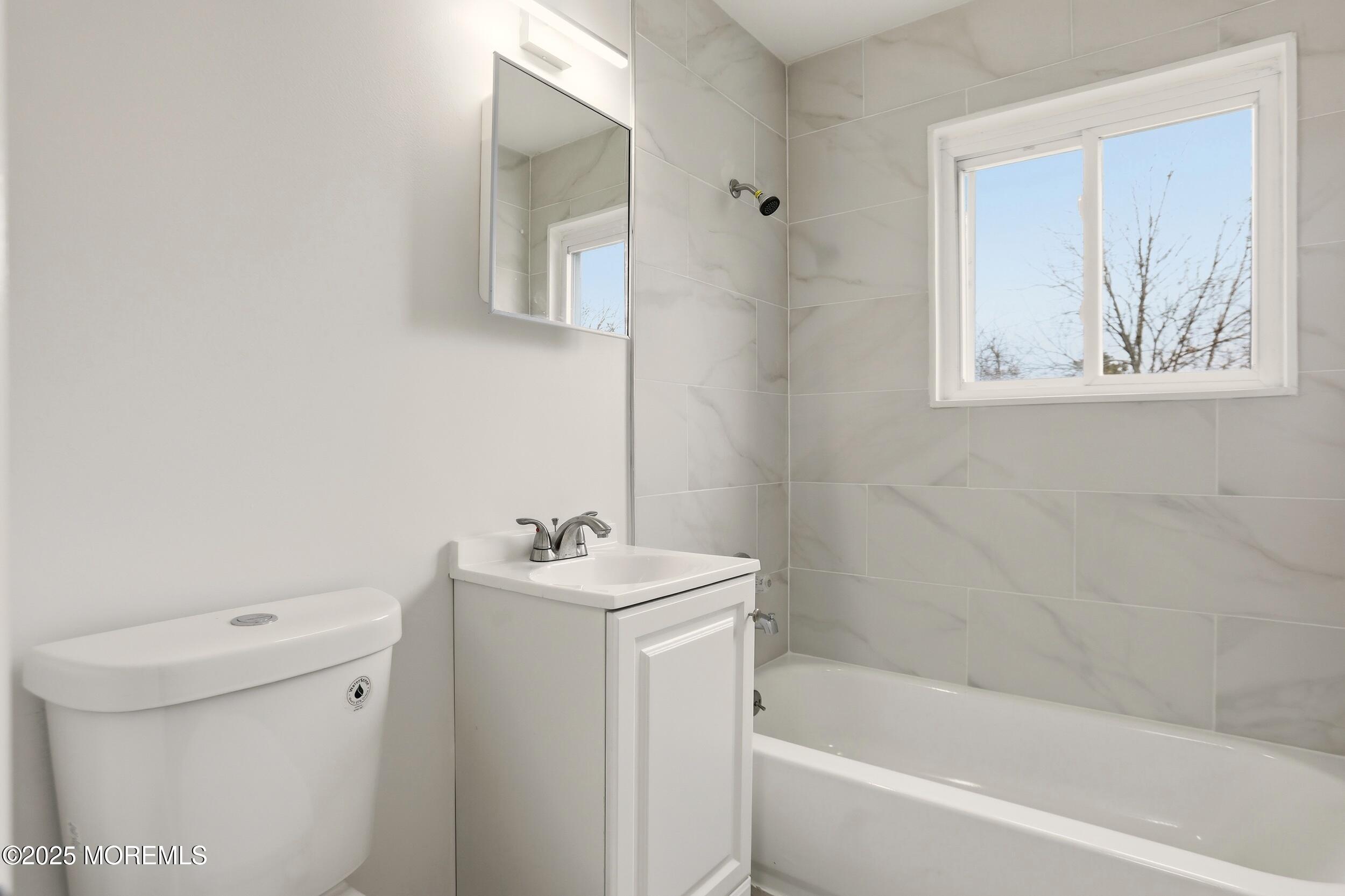 28 Brandies Road Toms River, NJ 08757 - Photo 23 of 30 a bathroom with a bathtub sink and toilet