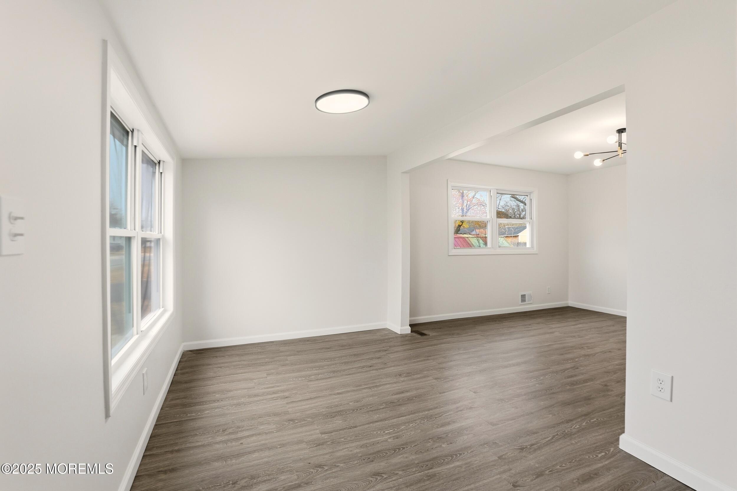 28 Brandies Road Toms River, NJ 08757 - Photo 6 of 30 an empty room with wooden floor and windows