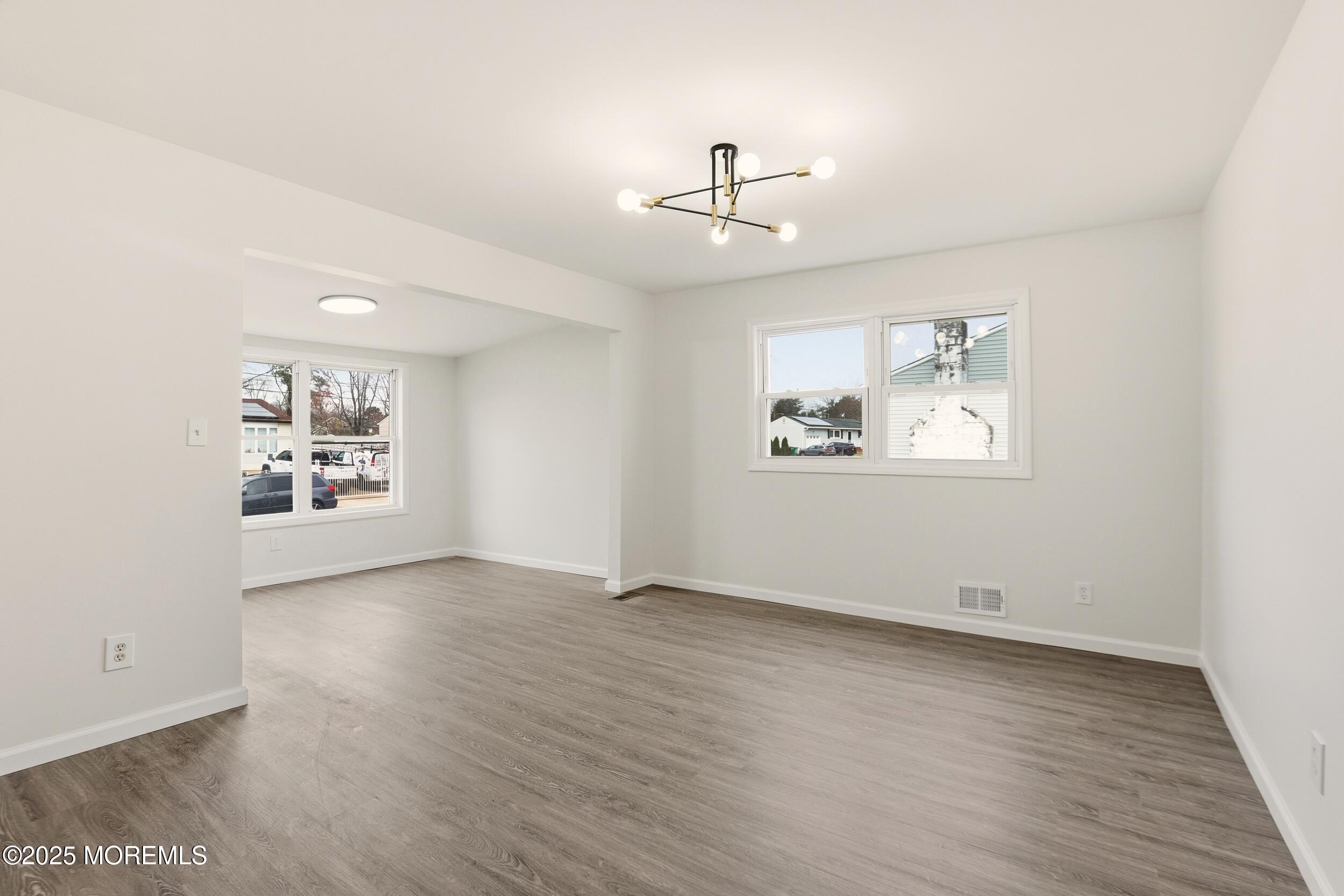 28 Brandies Road Toms River, NJ 08757 - Photo 9 of 30 wooden floor in an empty room with a window