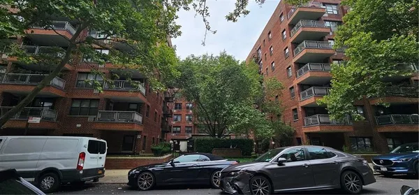 a couple of cars parked in front of a building