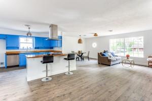 a living room with furniture and a kitchen area