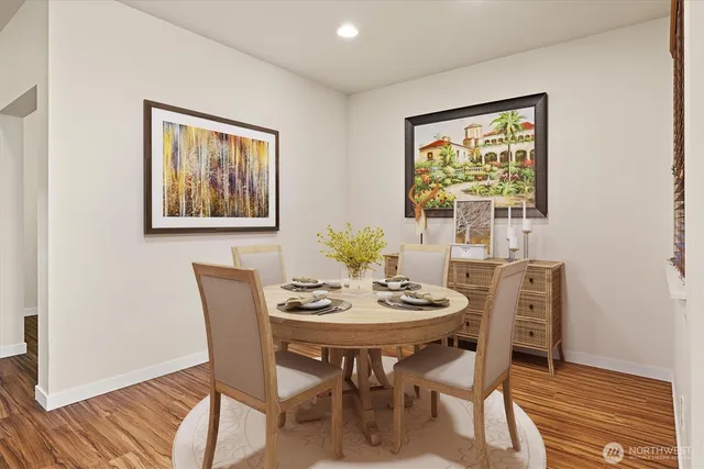 a dining room with furniture and wooden floor