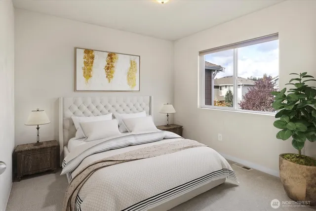 a bedroom with a bed and a potted plant