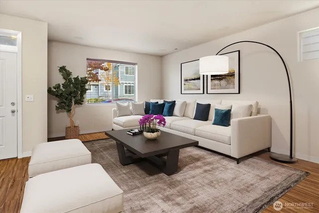 a living room with furniture and wooden floor