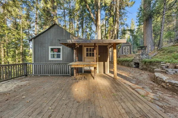 a view of a house with wooden deck and backyard