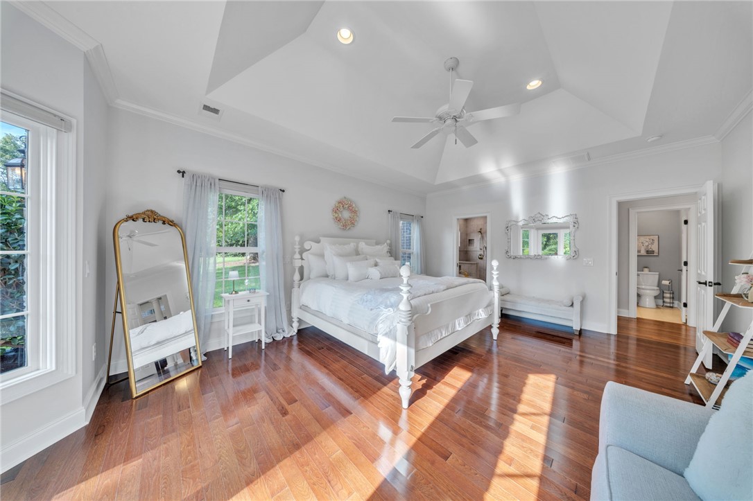 102 Country Walk Lane Clemson, SC 29631 - Photo 16 of 39 Warm hardwood floors and a striking tray ceiling define this generous primary bedroom space.