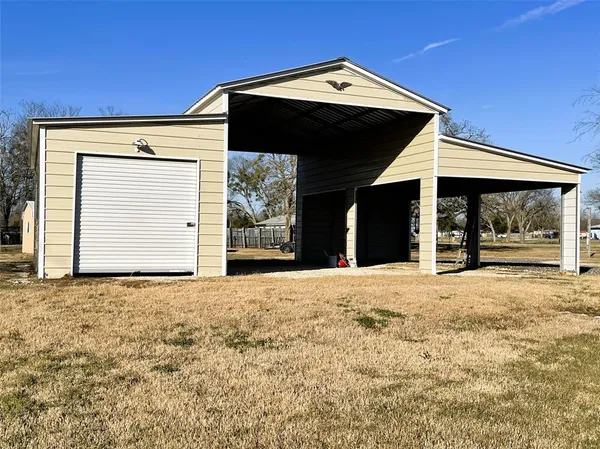 a view of a house with a wooden fence