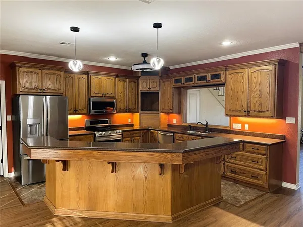 a kitchen with stainless steel appliances granite countertop a sink and a cabinets