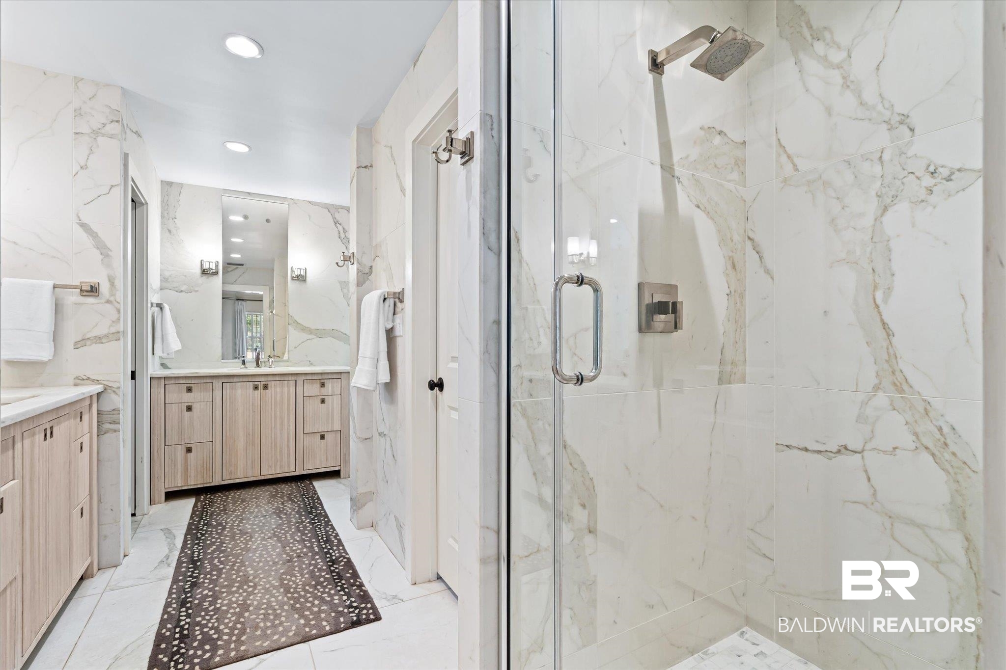 3921 McGregor Court Mobile, AL 36608 - Photo 19 of 41 Bathroom with a marble finish shower, marble finish floor, vanity, and stone wall