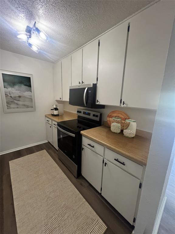 4639 Williams Road, Unit 113 Benbrook, TX 76116 - Photo 3 of 13 a kitchen with a stove cabinets and wooden floor