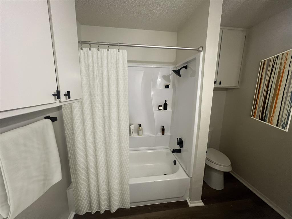 4639 Williams Road, Unit 113 Benbrook, TX 76116 - Photo 8 of 13 a bathroom with a shower curtain and a sink