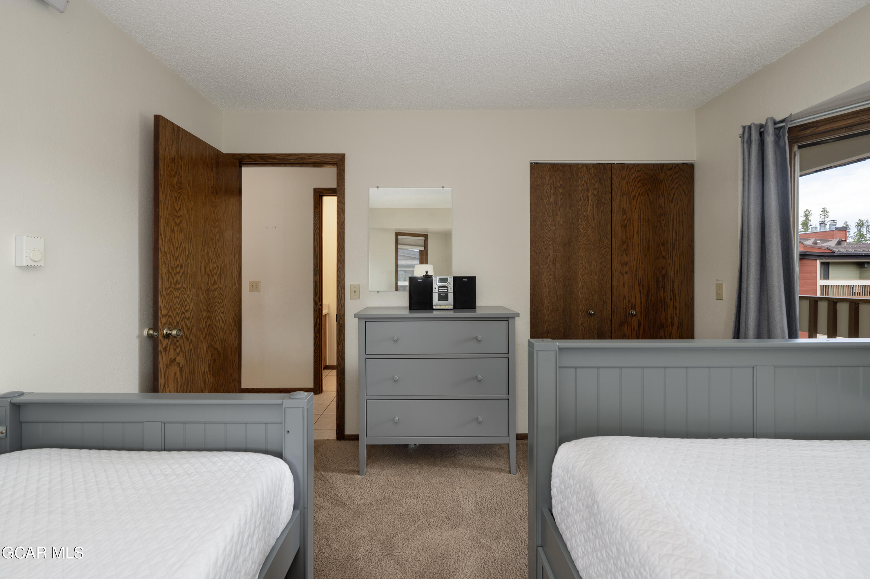 490 Kings Crossing Road, Unit 331 Winter Park, CO 80482 - Photo 16 of 38 a bedroom with a bed and a dresser