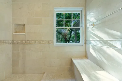 a en suite bathroom with a granite countertop window and a shower