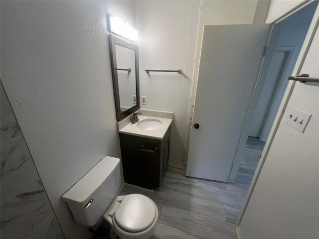 a white toilet sitting next to a bath tub and a shower