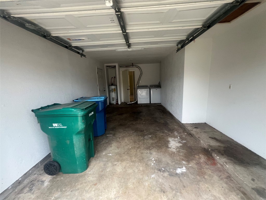 807 Lloyd Lane, Unit A Elgin, TX 78621 - Photo 11 of 16 Garage featuring independent washer and dryer and electric water heater
