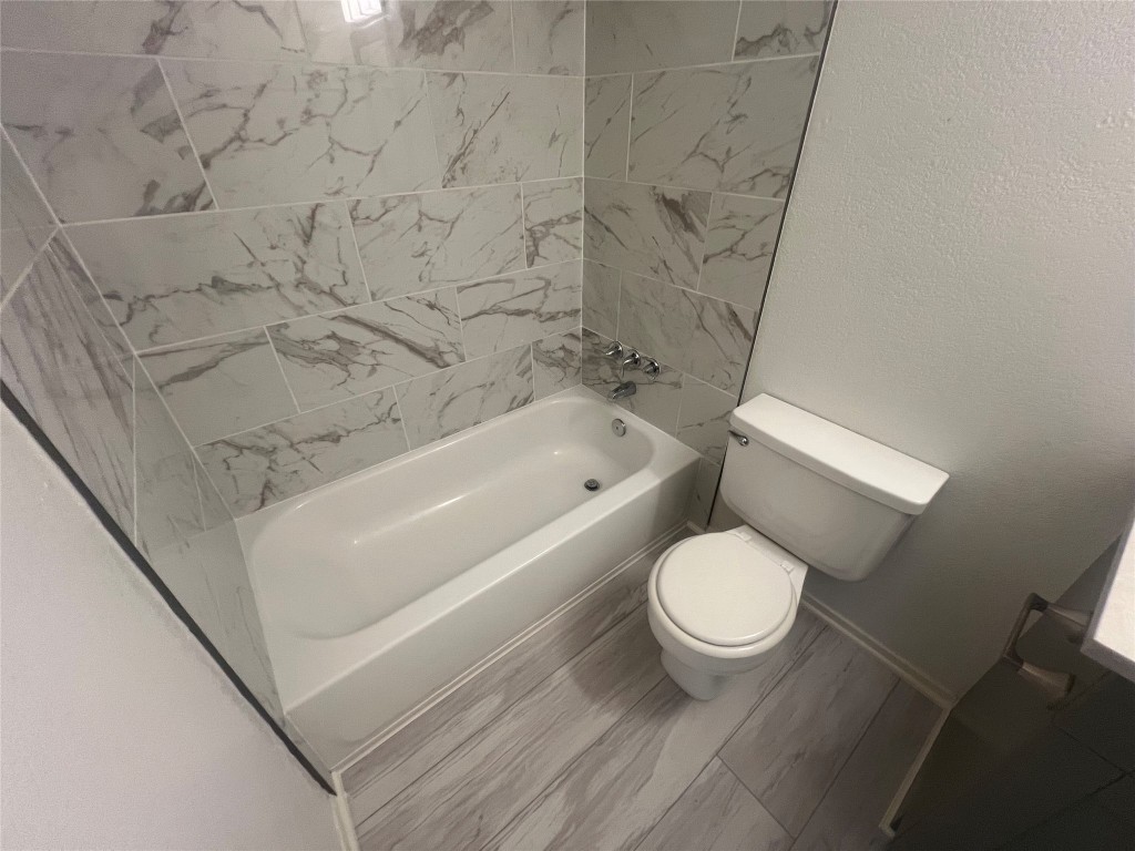 807 Lloyd Lane, Unit A Elgin, TX 78621 - Photo 9 of 16 Bathroom with shower / washtub combination and a textured wall