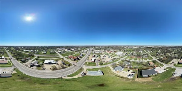 an aerial view of a house with a big yard