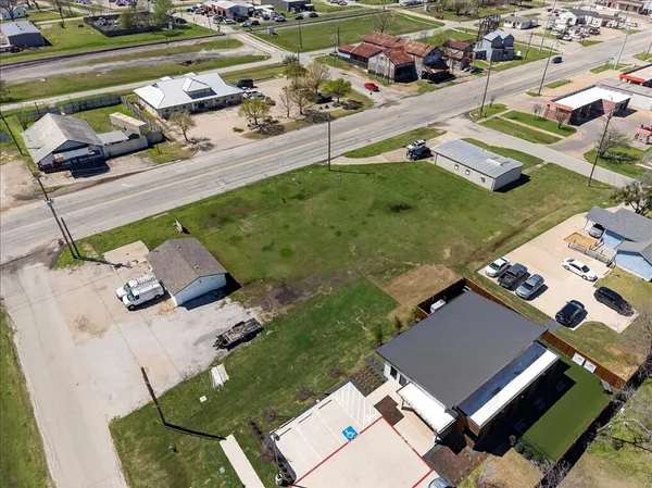 an aerial view of a house with garden space and street view