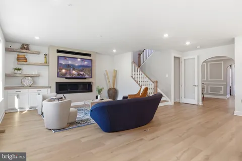 a open kitchen with white cabinets and refrigerator