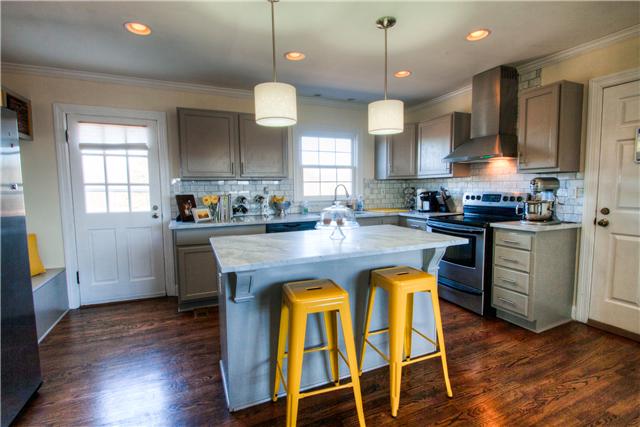 1210 Palmer Road Lebanon, TN 37090 - Photo 10 of 20 a kitchen with granite countertop wooden floors cabinets a dining table and appliances